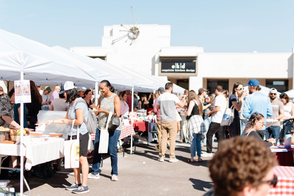 Crowds sampling goods from outdoor tents during Denver Bake Fest