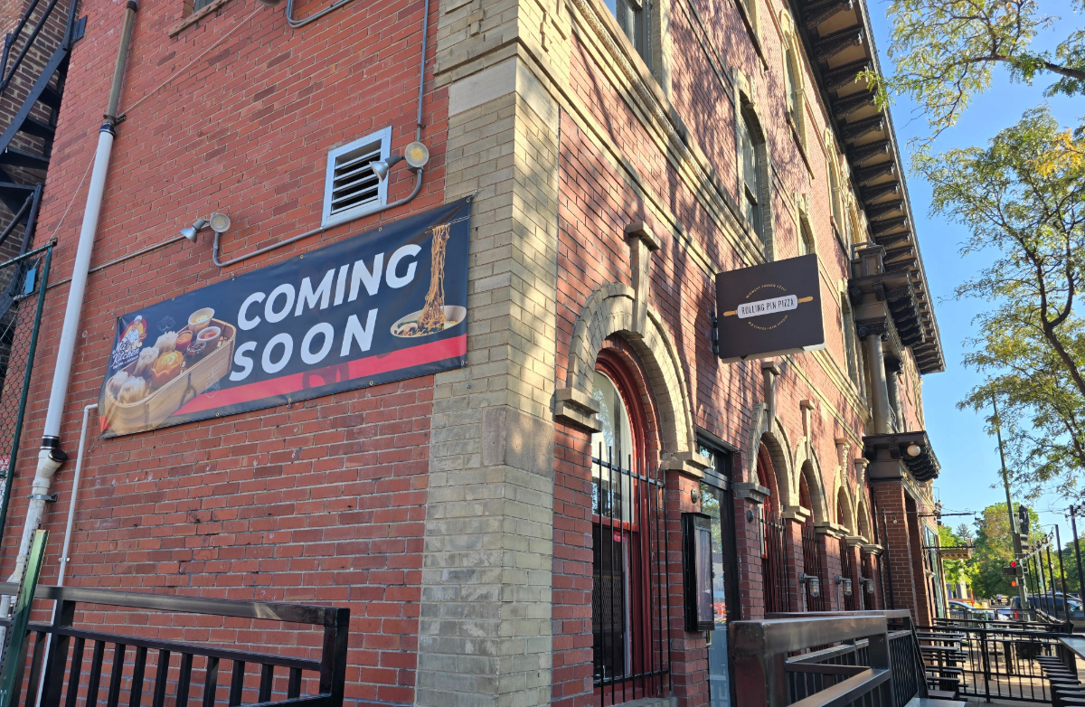 "coming soon' banner on a brick building