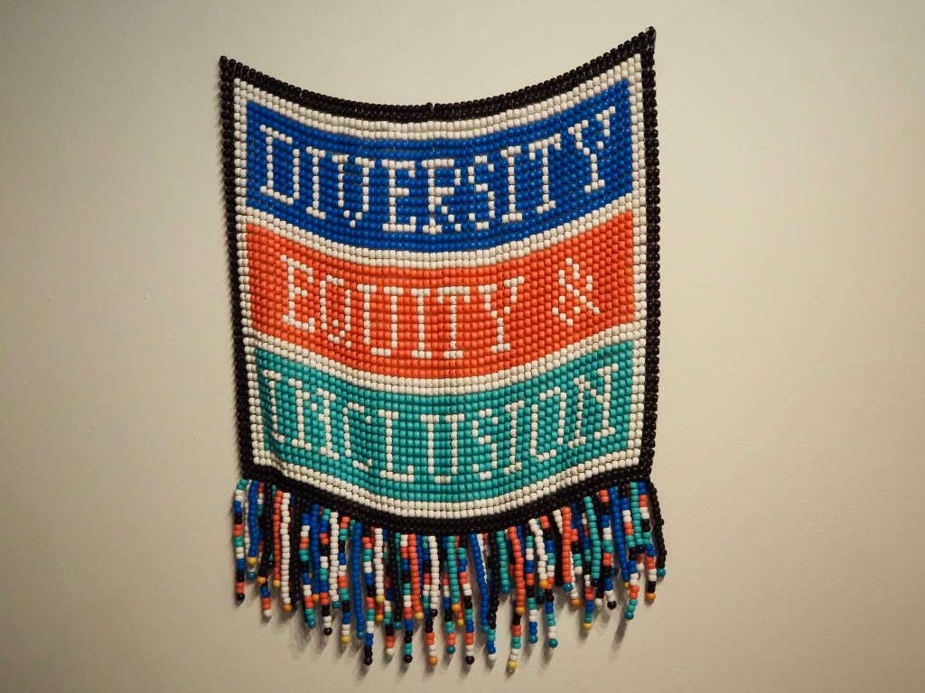 A beaded banner reading "Diversity, Equity & Inclusion"