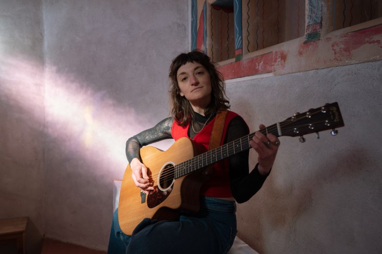 person with an acoustic guitar