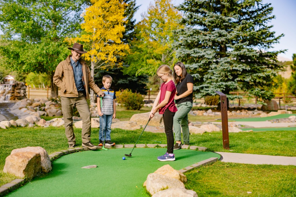 A family mini golfing at YMCA of the Rockies