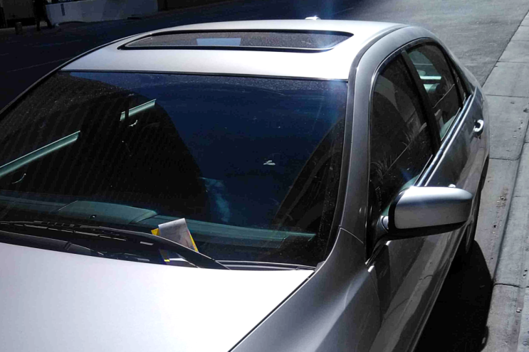 car with parking ticket in windshield