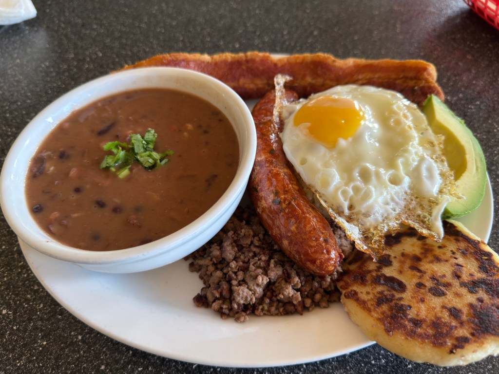 a plate of meat, beans, and egg.
