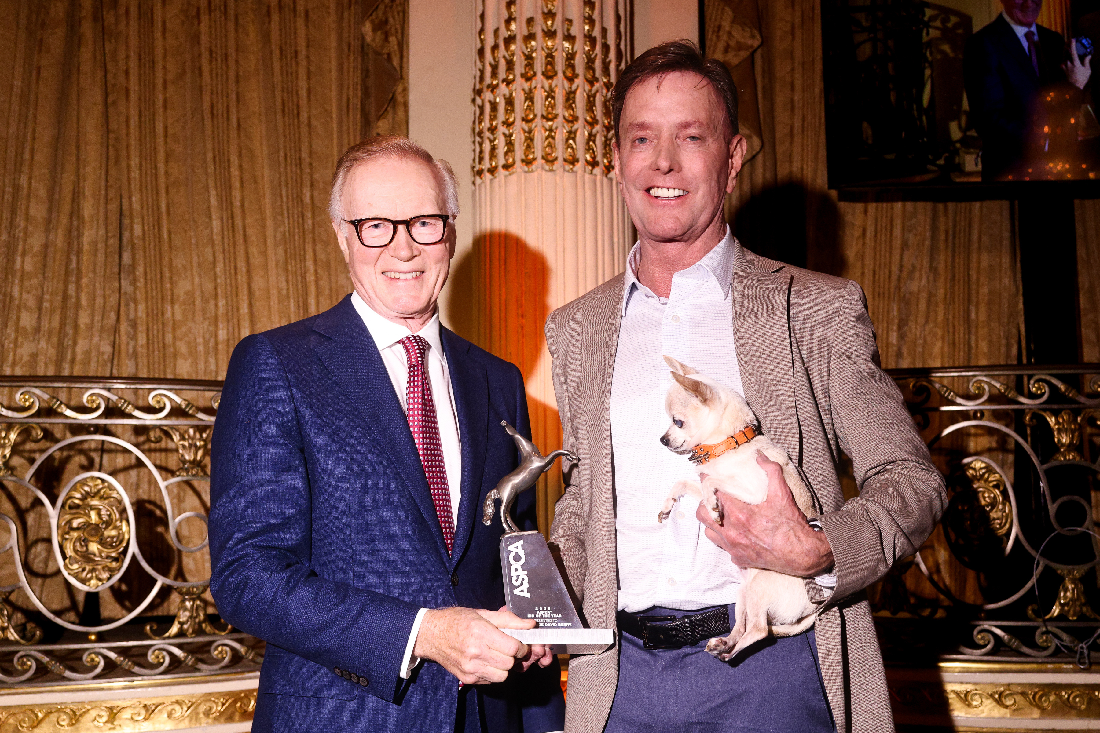 two men shake hands during award handoff