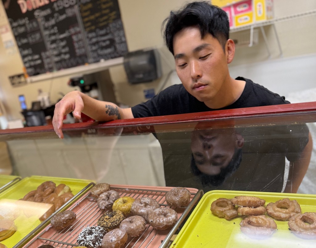 a man looking at donuts