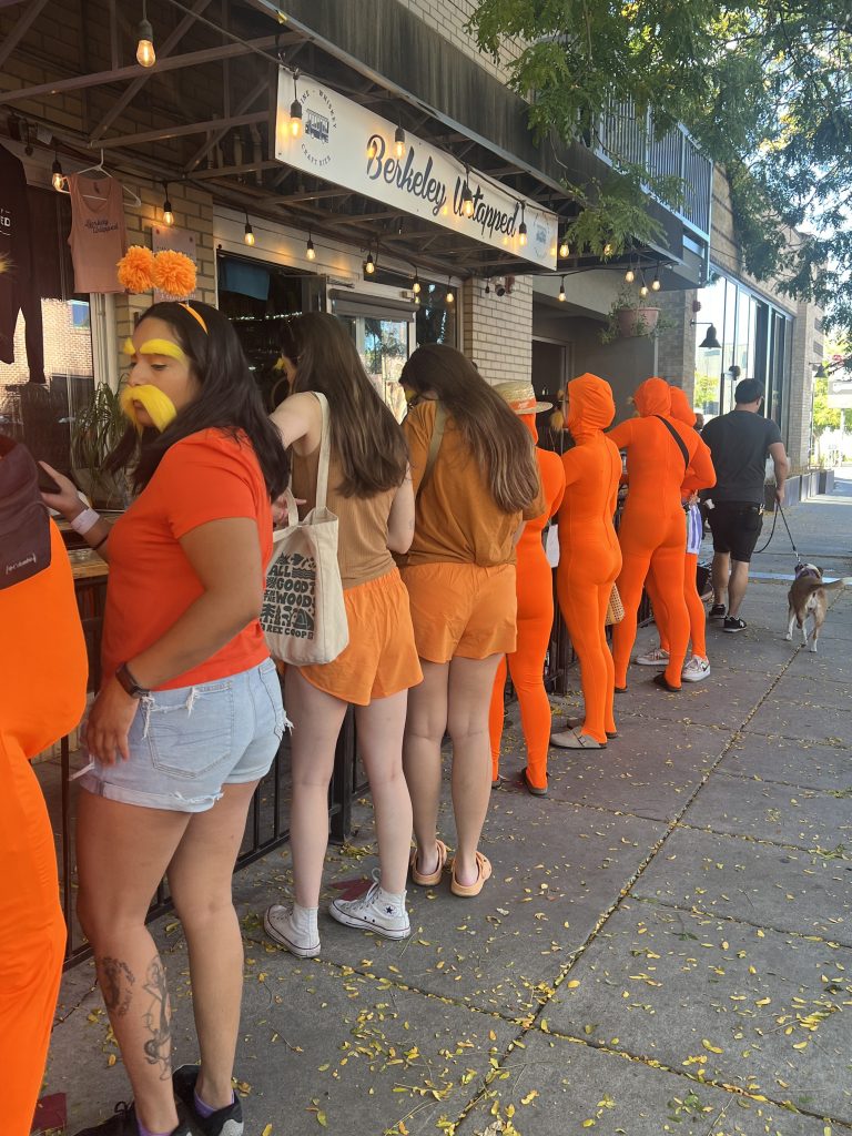 People dressed as the lorax wait in line at a bar