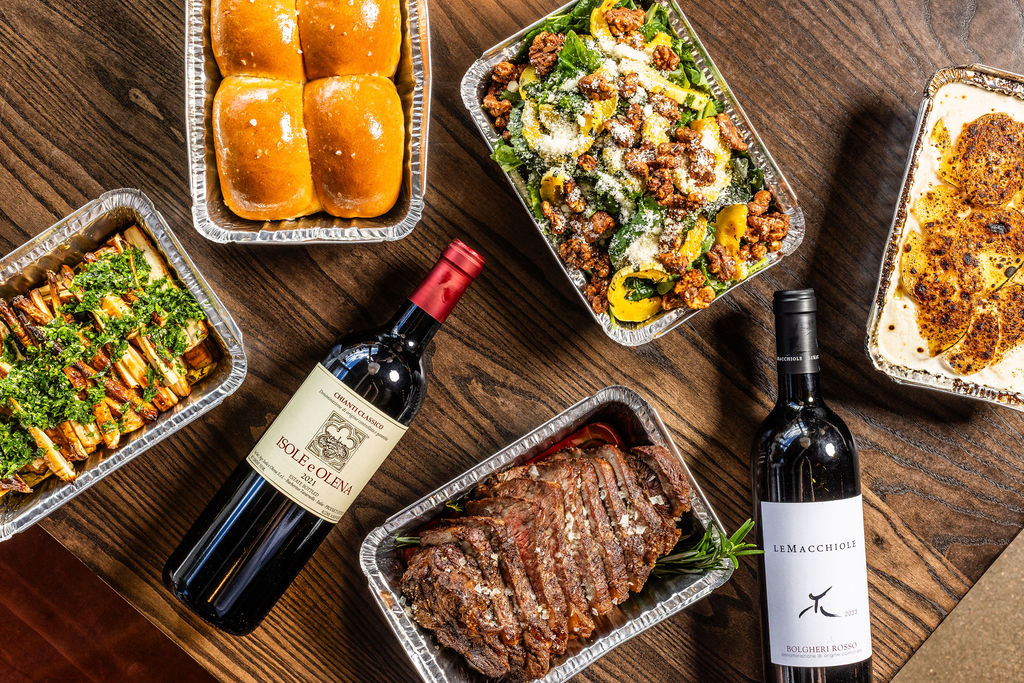 Stuffing, steak, bottles of wine and other dishes part of Osteria Alberico's Thanksgiving meal