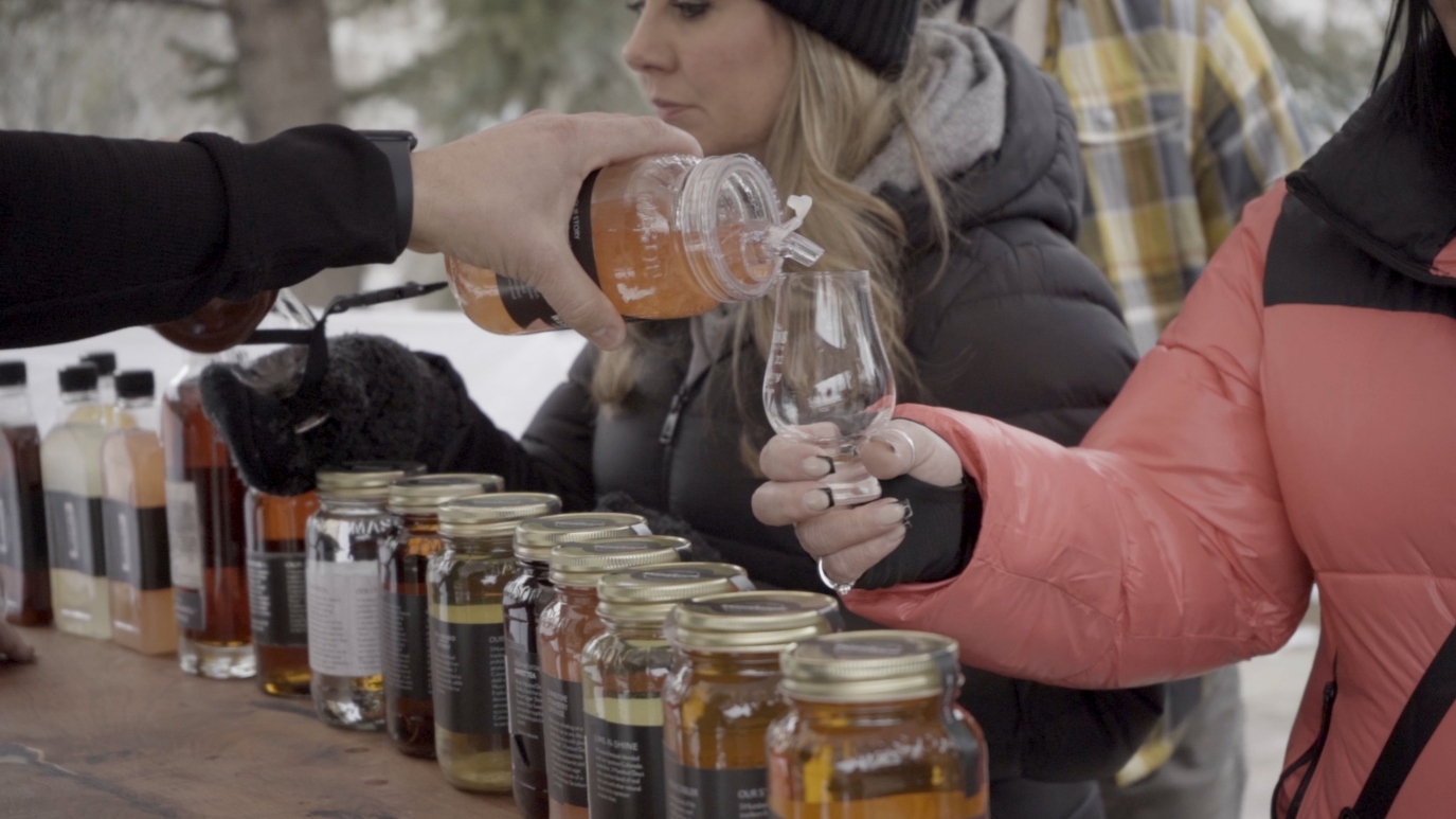 people pour drinks at an outdoor bar
