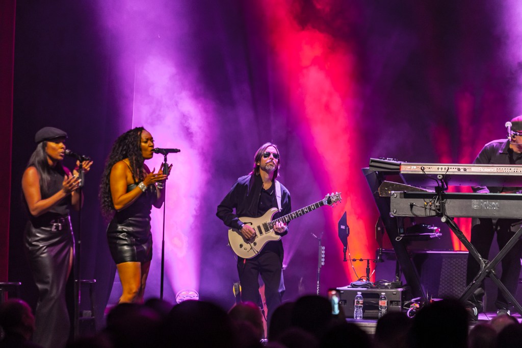 John Legend's band performing on stage at the Paramount Theatre on Wednesday, November 19.