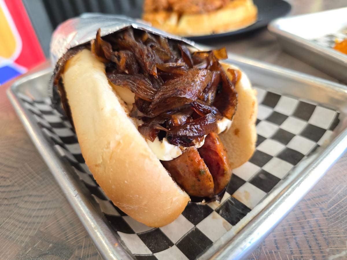 elk jalapeno cheddar dog topped with cream cheese and caramelized onions.