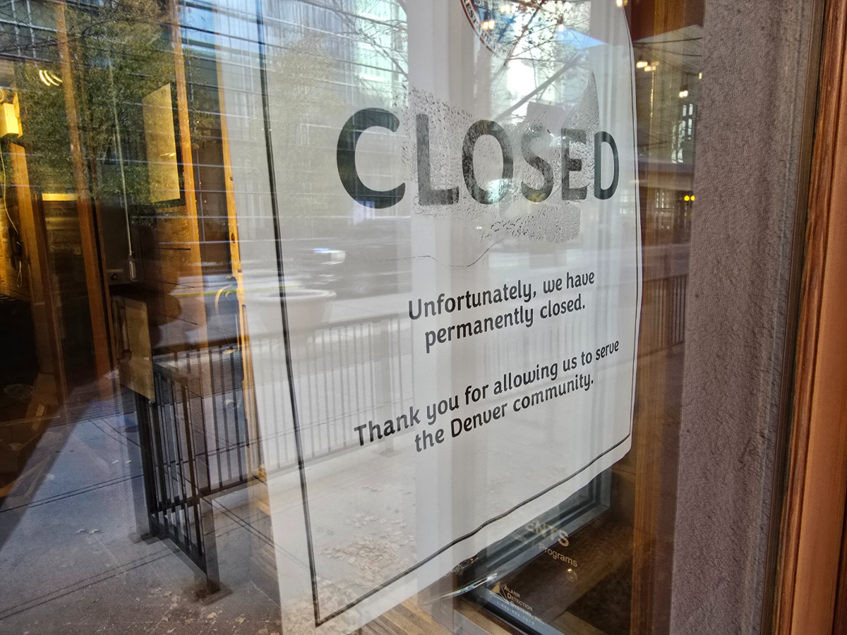 "closed" sign posted on a door