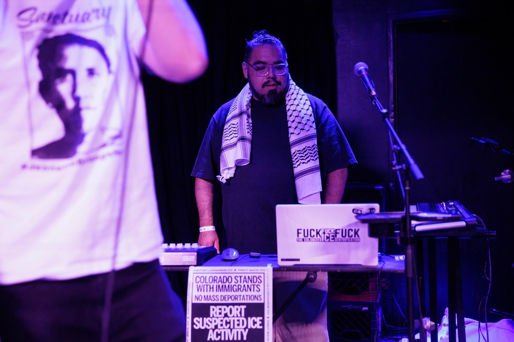 man standing behind a laptop