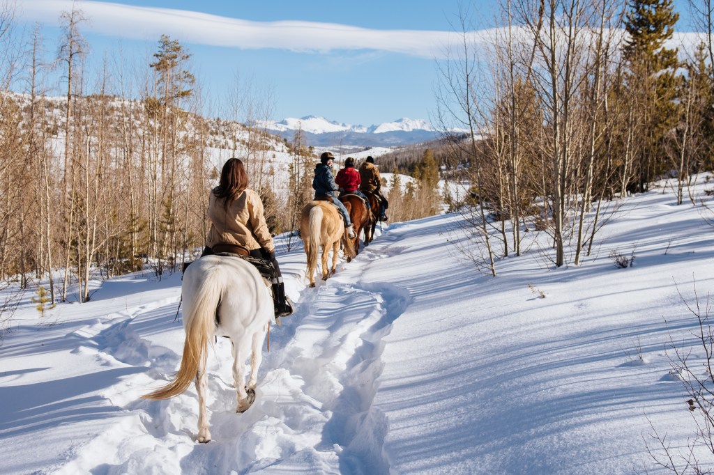 A group on a winter horseback ride at C Lazy U Ranch