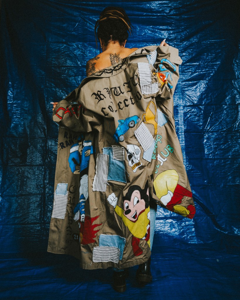Model wearing a patchwork trench coat hand-painted by Joshua Ryuju.