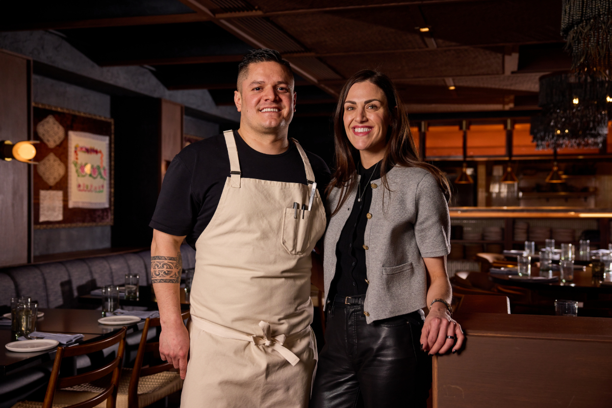man and woman posing in a restaurant