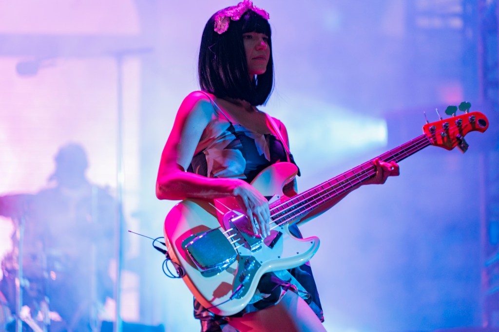 A person plays guitar and performs