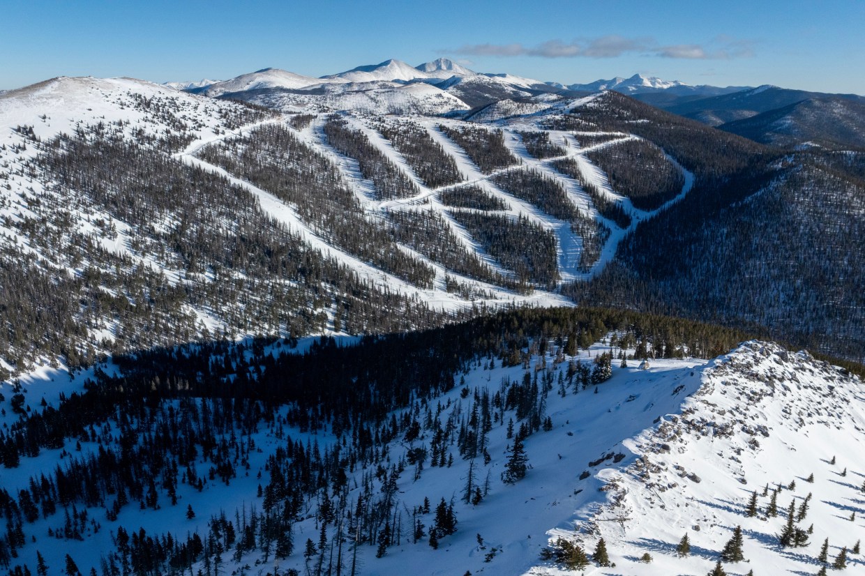 An aerial view of No Name Basin, featuring snowy runs cut through the trees