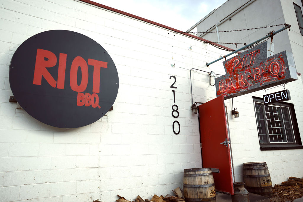 "riot bbq" sign on a building