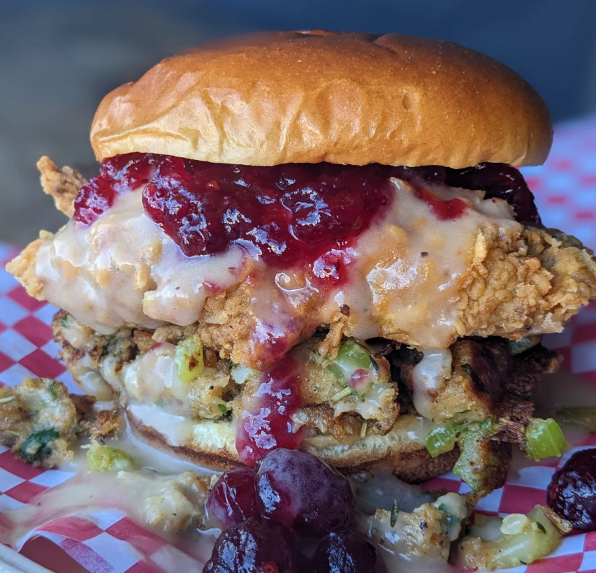 fried chicken sandwich with cranberry and stuffing.