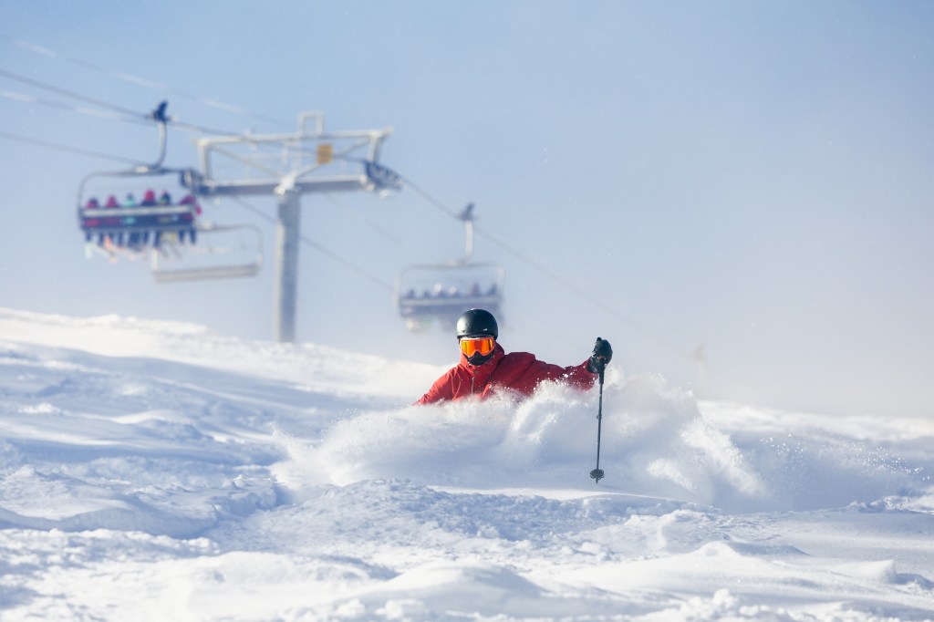 A skier in deep powder at Snowmass Ski Resort