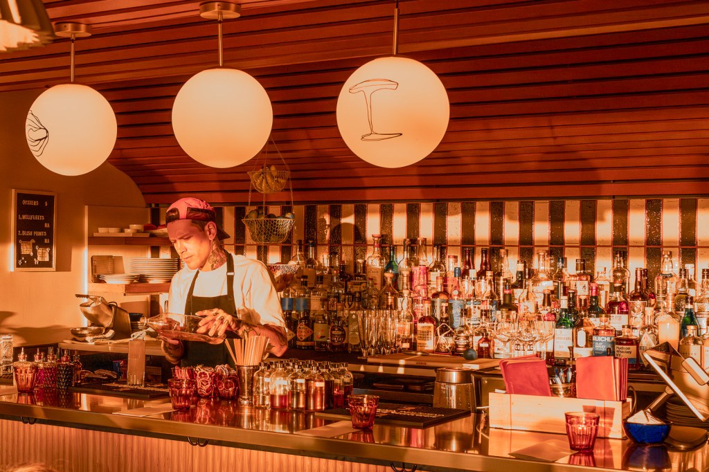 person working behind a bar