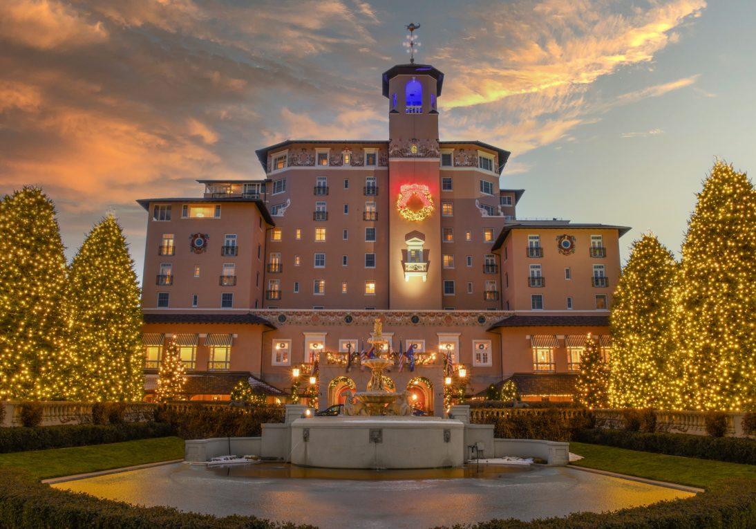 A big hotel with a pond in front