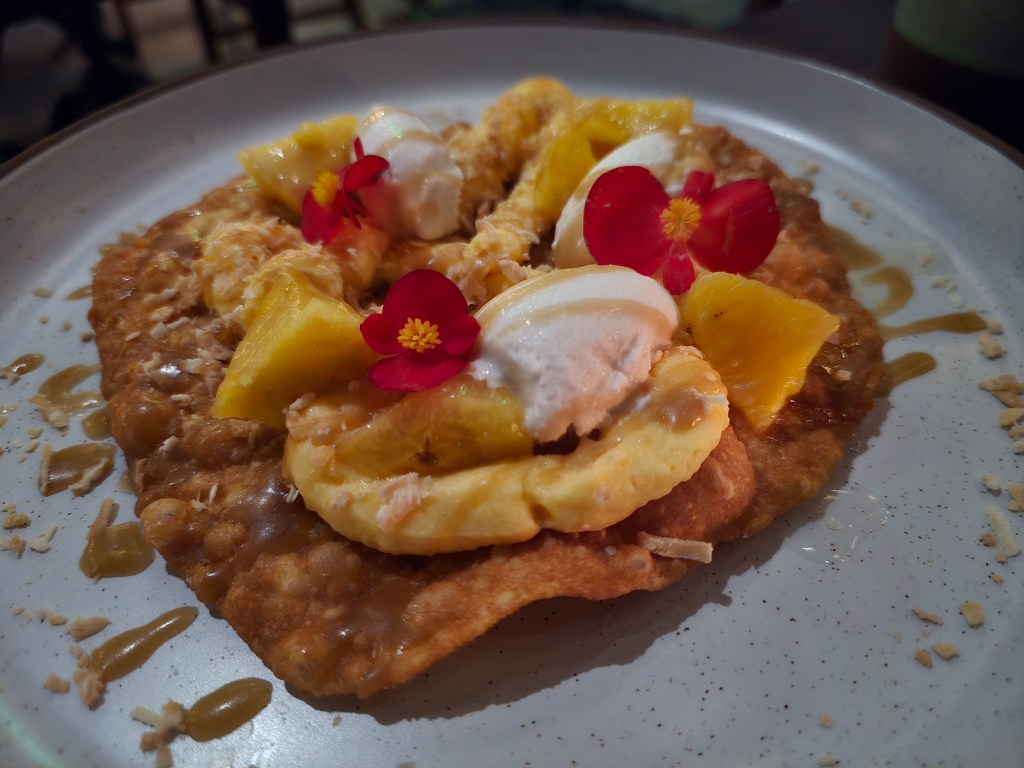 Peruvian fried flatbread topped with passion fruit cream, roasted pineapple and coconut sorbet