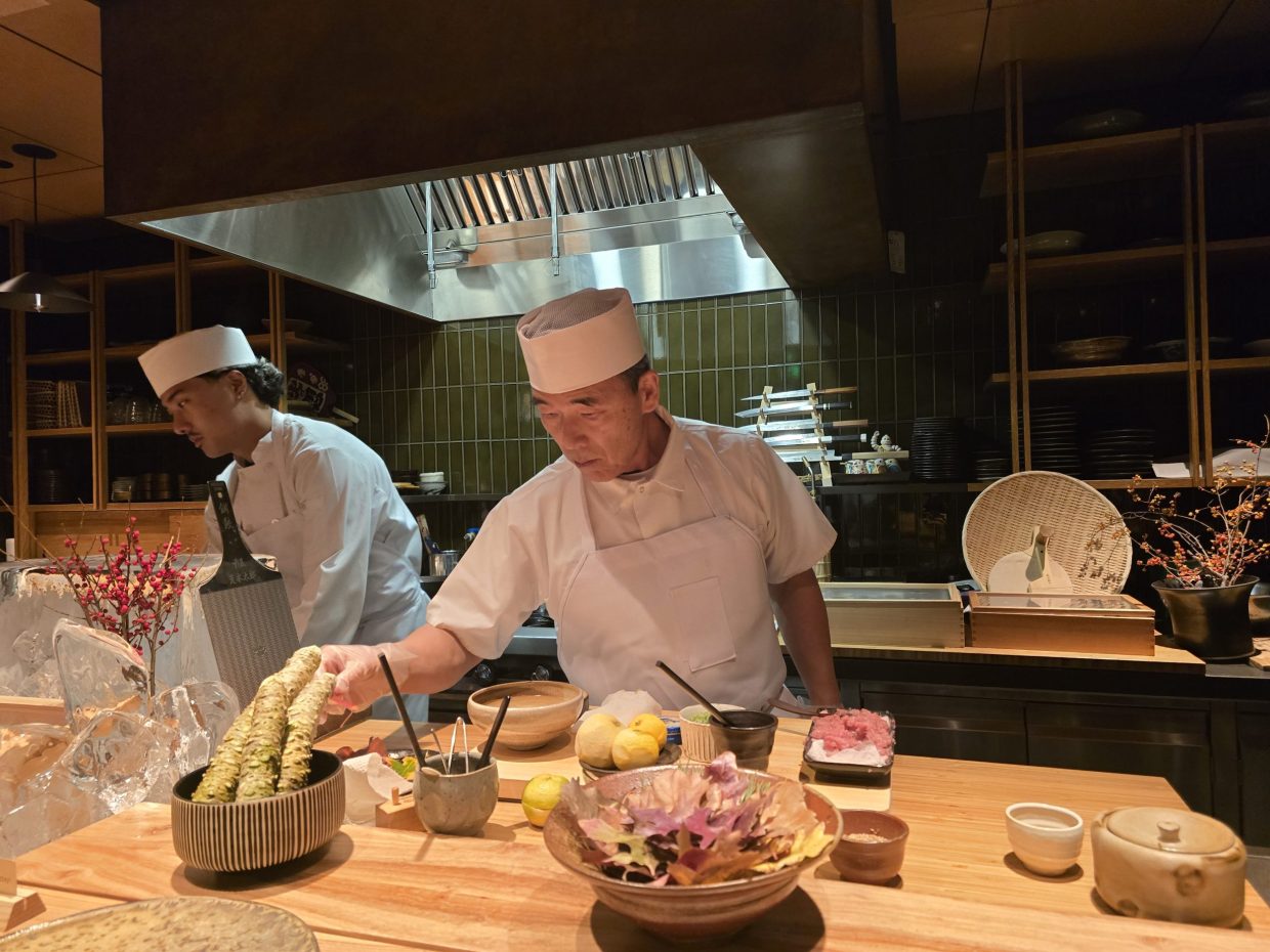 chef behind sushi counter
