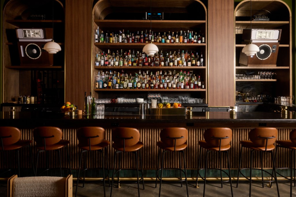 stools lined up in front of a bar