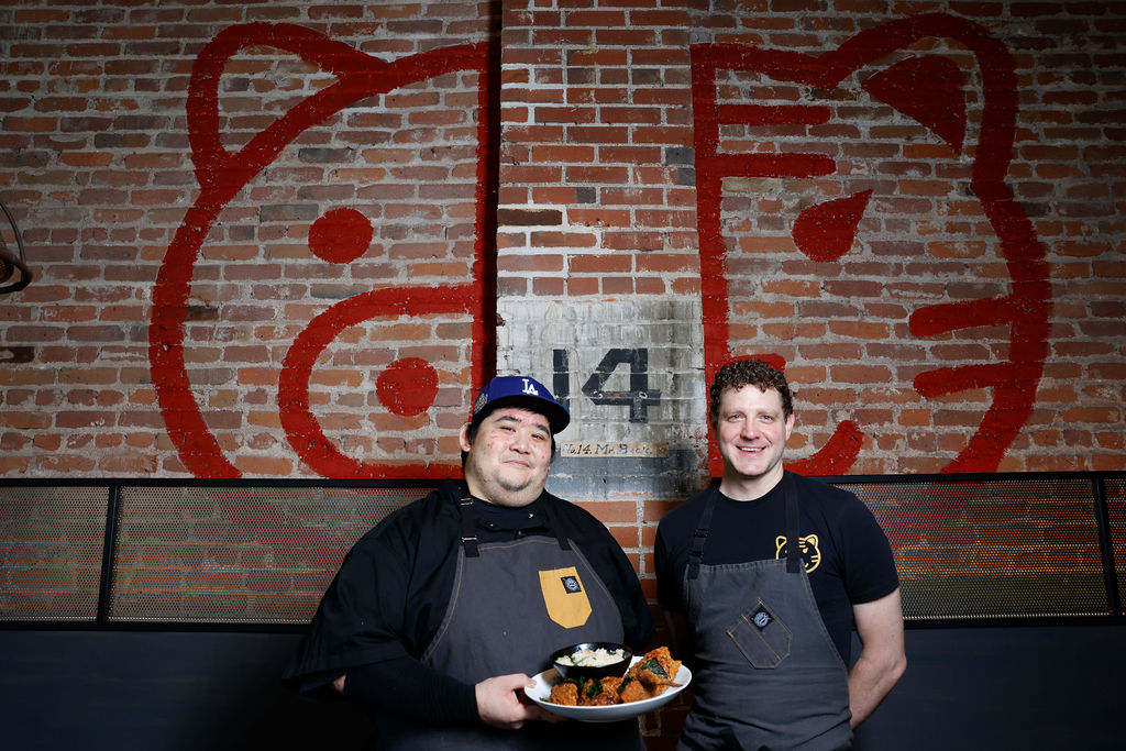 two men in aprons posing