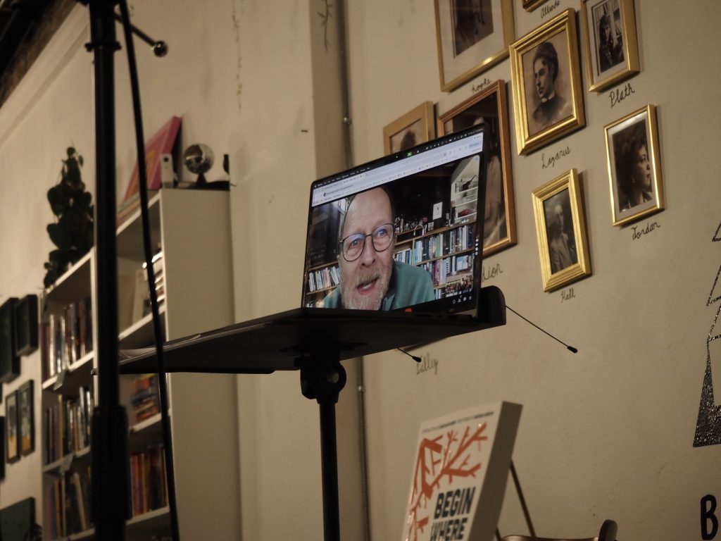 A man on a laptop talks