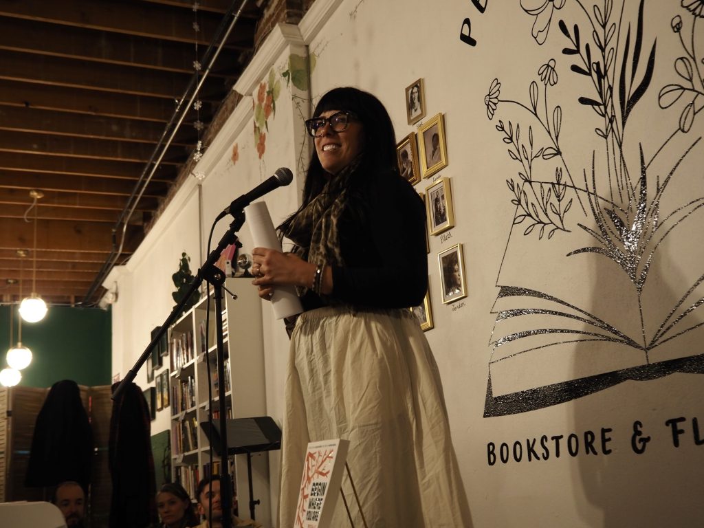 A person reads at a microphone