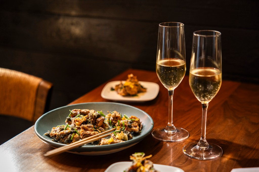 Two glasses of champange and chicken karaage from Uchi