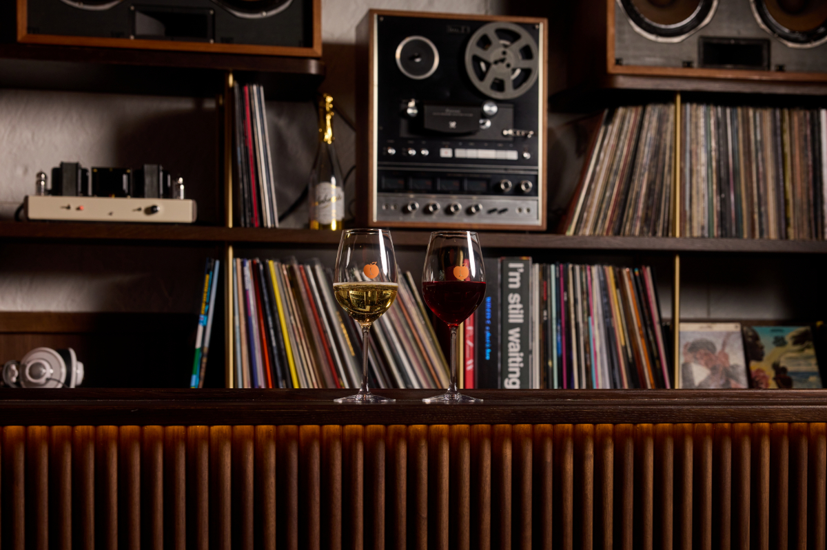 two glasses of wine on a shelf