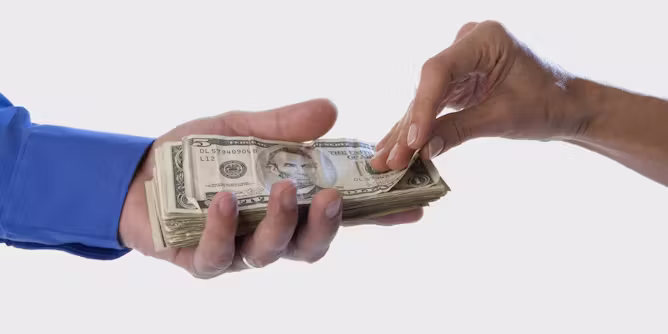 man handing over money