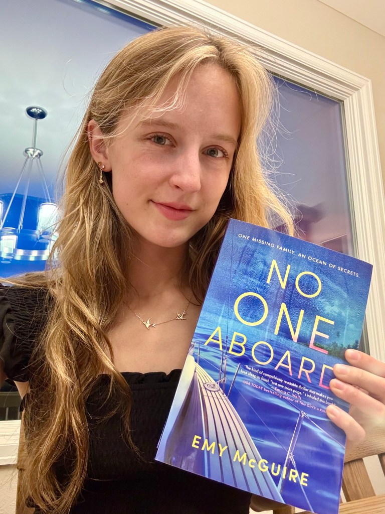 Emy McGuire holds a copy of her book, No One Aboard