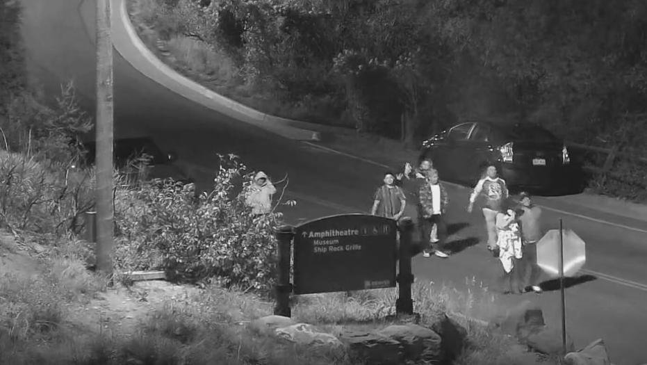 people walking through Red Rocks park at night