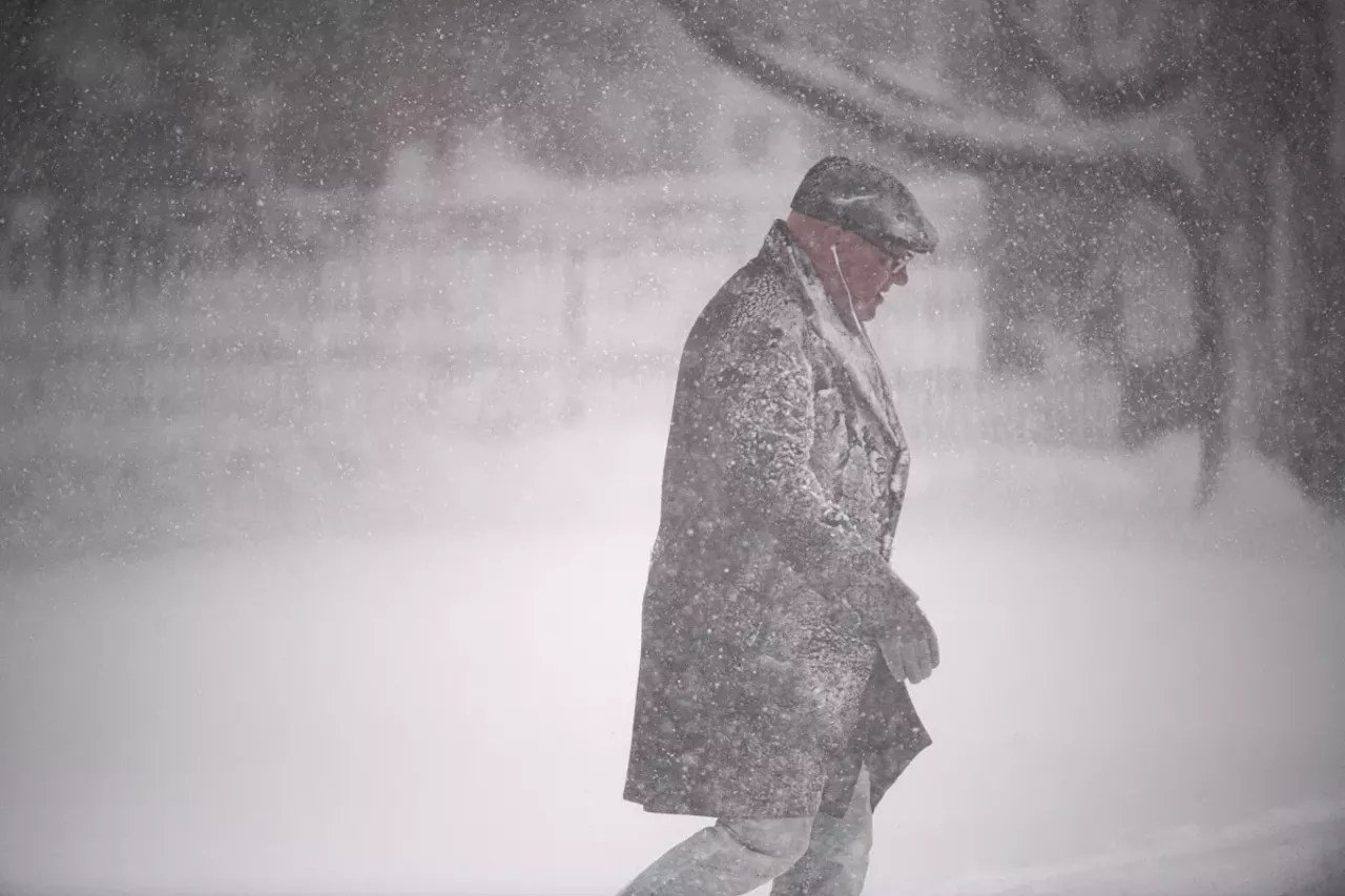 Man walks to Denver bus stop during blizzard