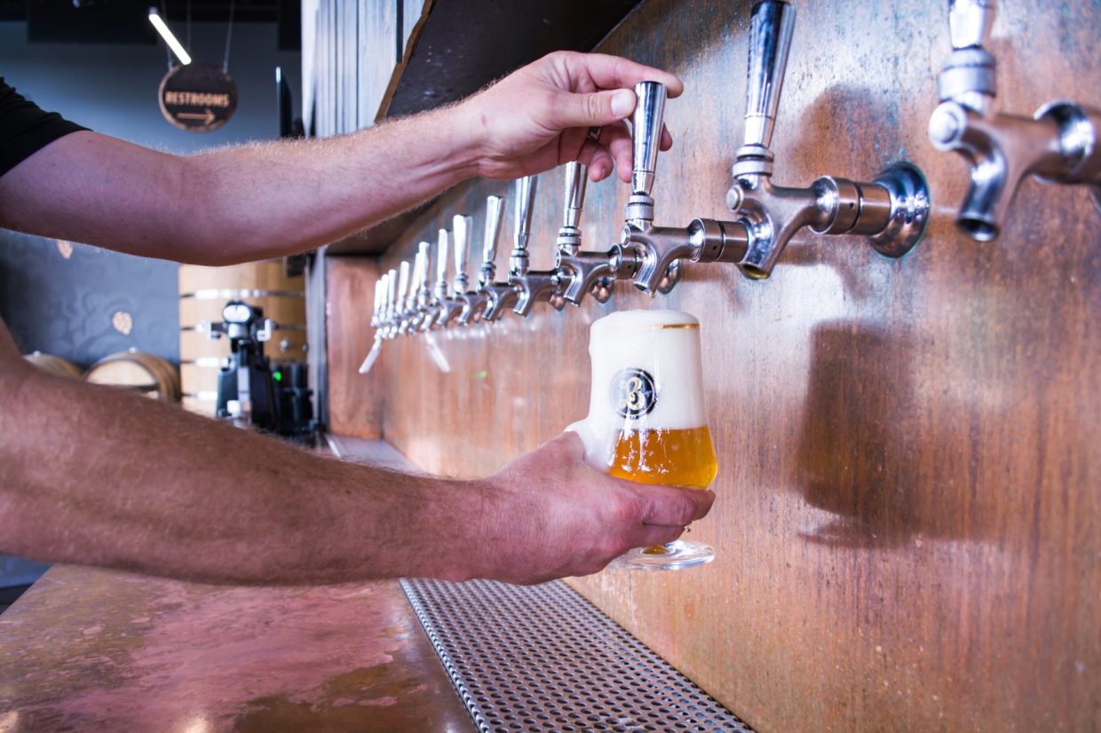 beer being poured from taps