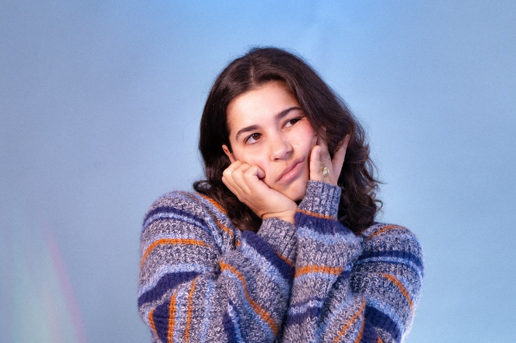 A comedian poses in a studio
