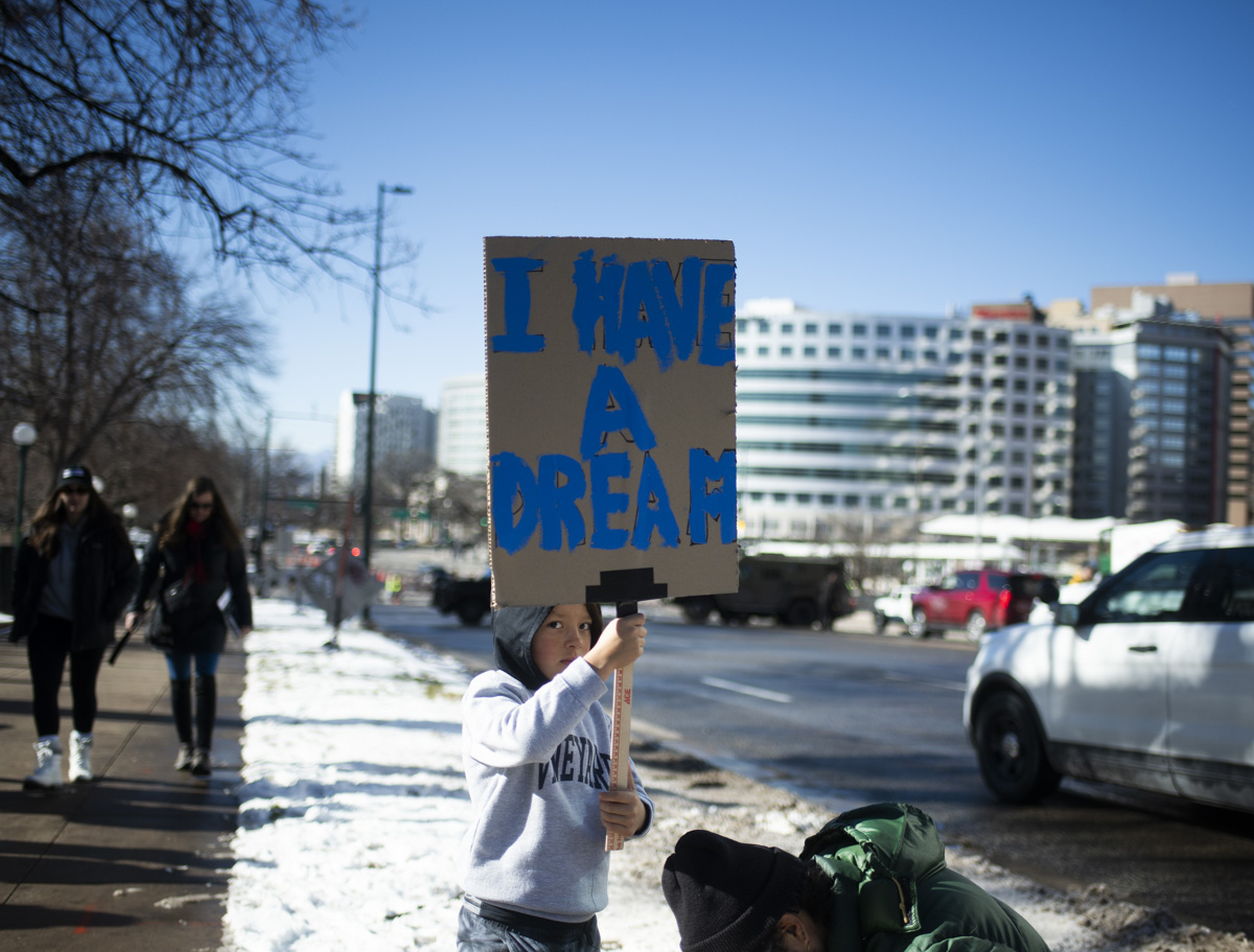 child holds MLK sign