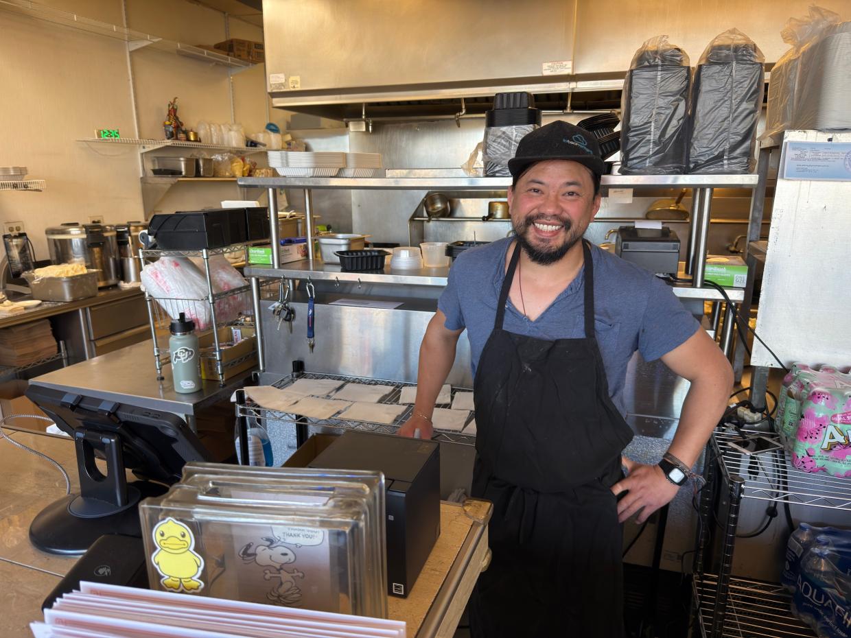 A man behind a restaurant counter