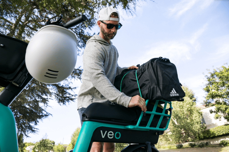 man loads up rented scooter