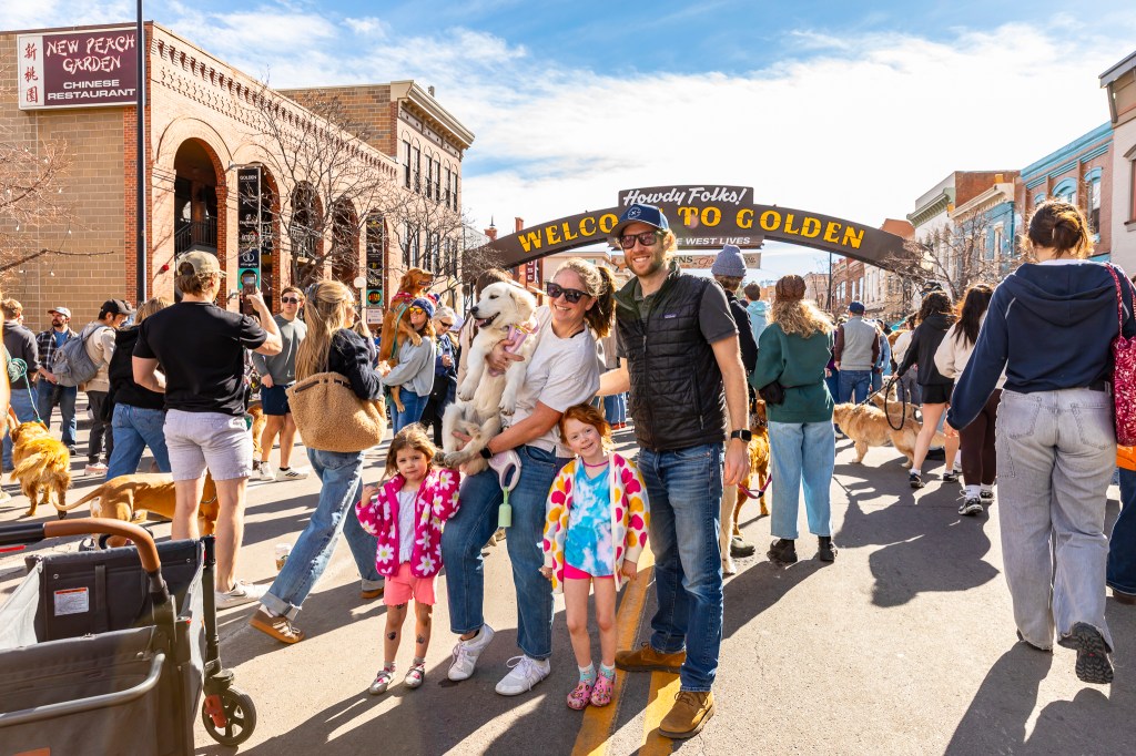 A family takes a group picture during the annual Golden's in Golden event.