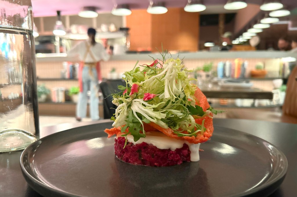 Beet "tartare" topped with yogurt, a crisp pink cracker and greens at Bin 707 Foodbar