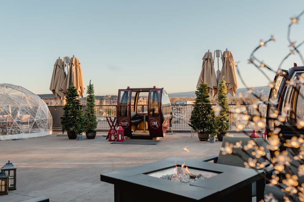 A gondola with its doors open, resting on the rooftop patio at Devil's Kitchen