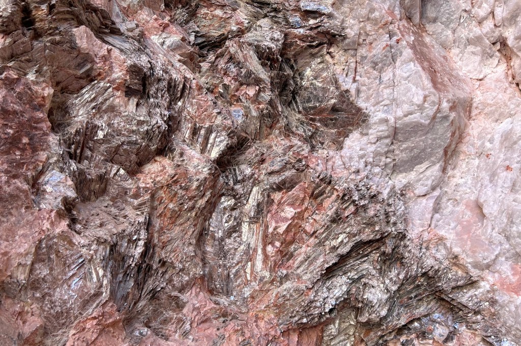 Silvery layers of mica embedded in rose-colored quartz on the Mica Mine Trail