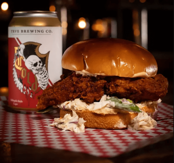 a hot chicken sandwich and a beer