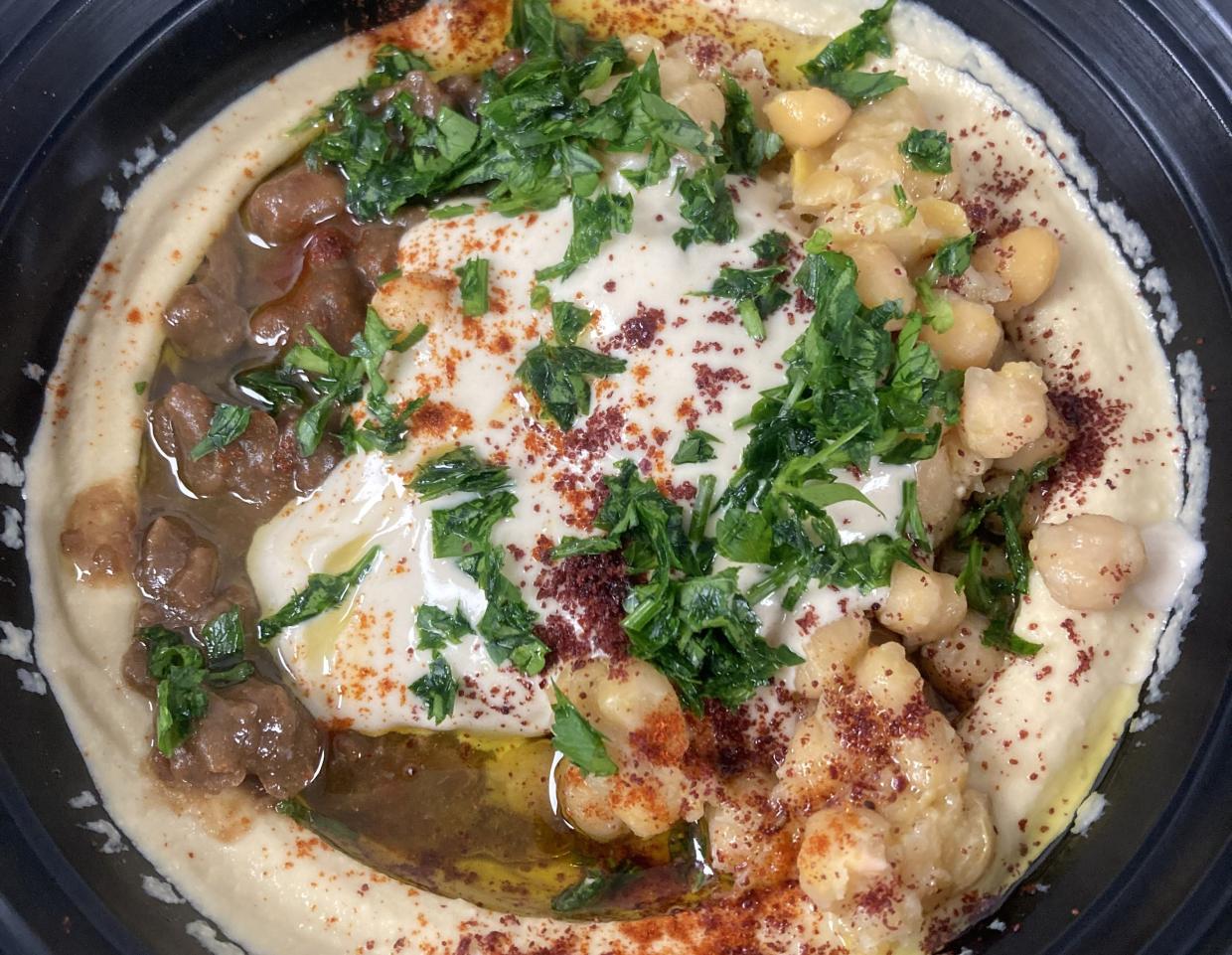 a plate of hummus with vegetables