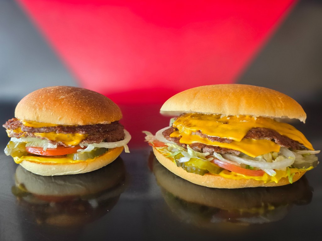 a small burger next to a large burger